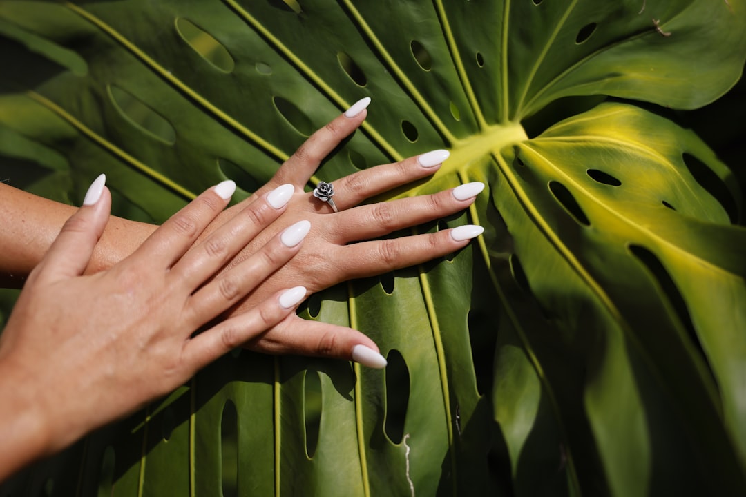 why-choose-us Silver tone rose ring and nice manicure with white acrylic nails.